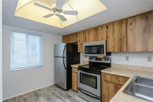 a kitchen with stainless steel appliances a stove microwave and refrigerator