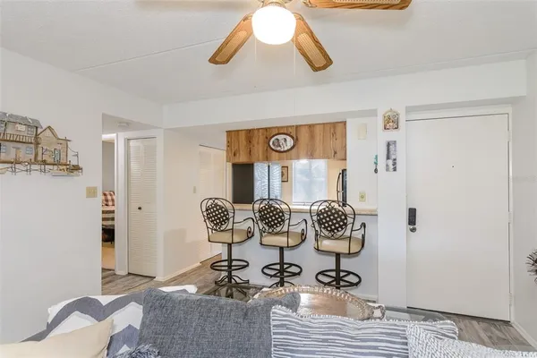 a bedroom with a bed chandelier and a window
