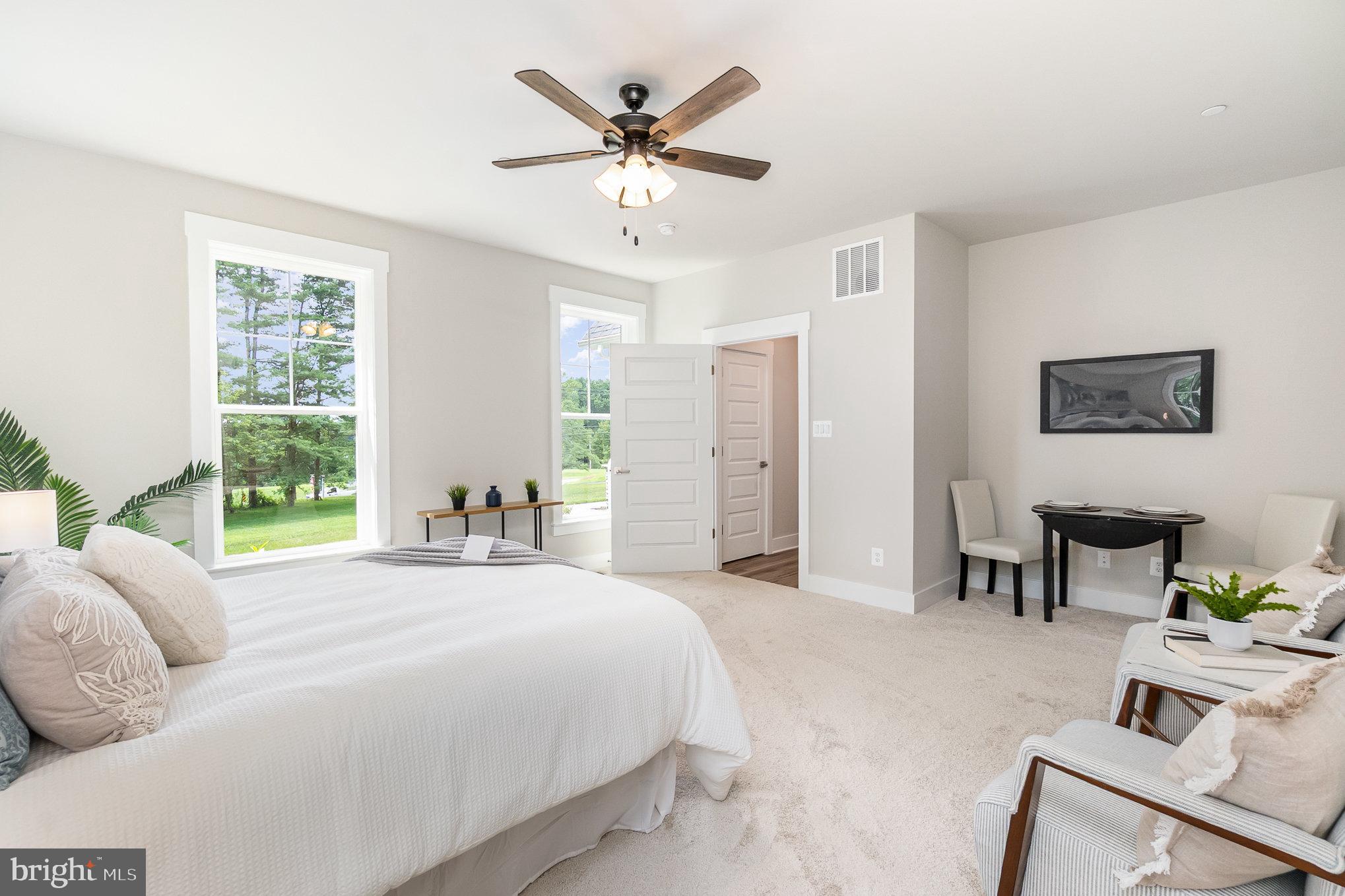 3104 Paper Mill Road Phoenix, MD 21131 - Photo 15 of 77 a spacious bedroom with a bed a window and a chandelier