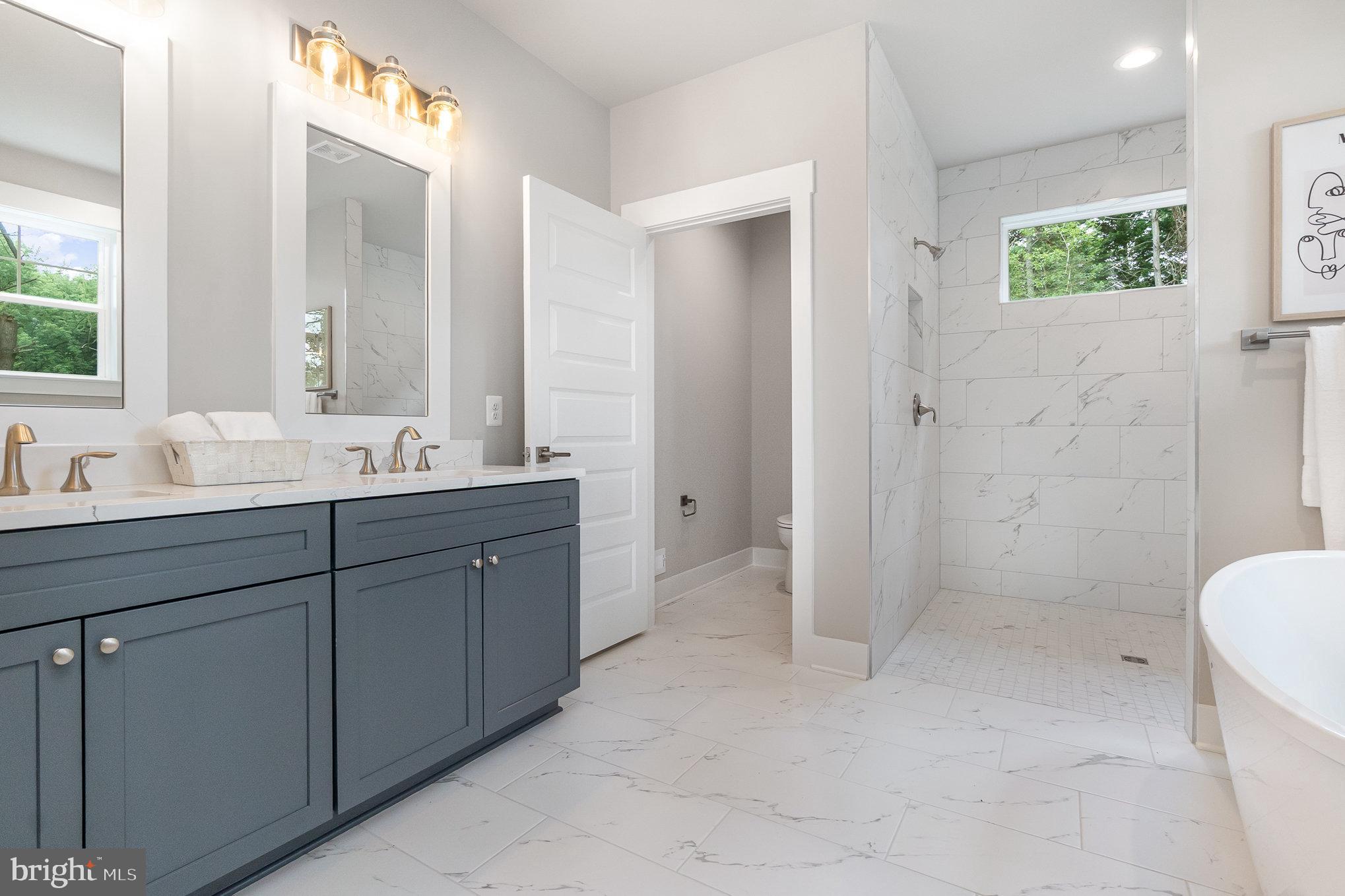 3104 Paper Mill Road Phoenix, MD 21131 - Photo 19 of 77 a bathroom with a double vanity sink toilet and shower