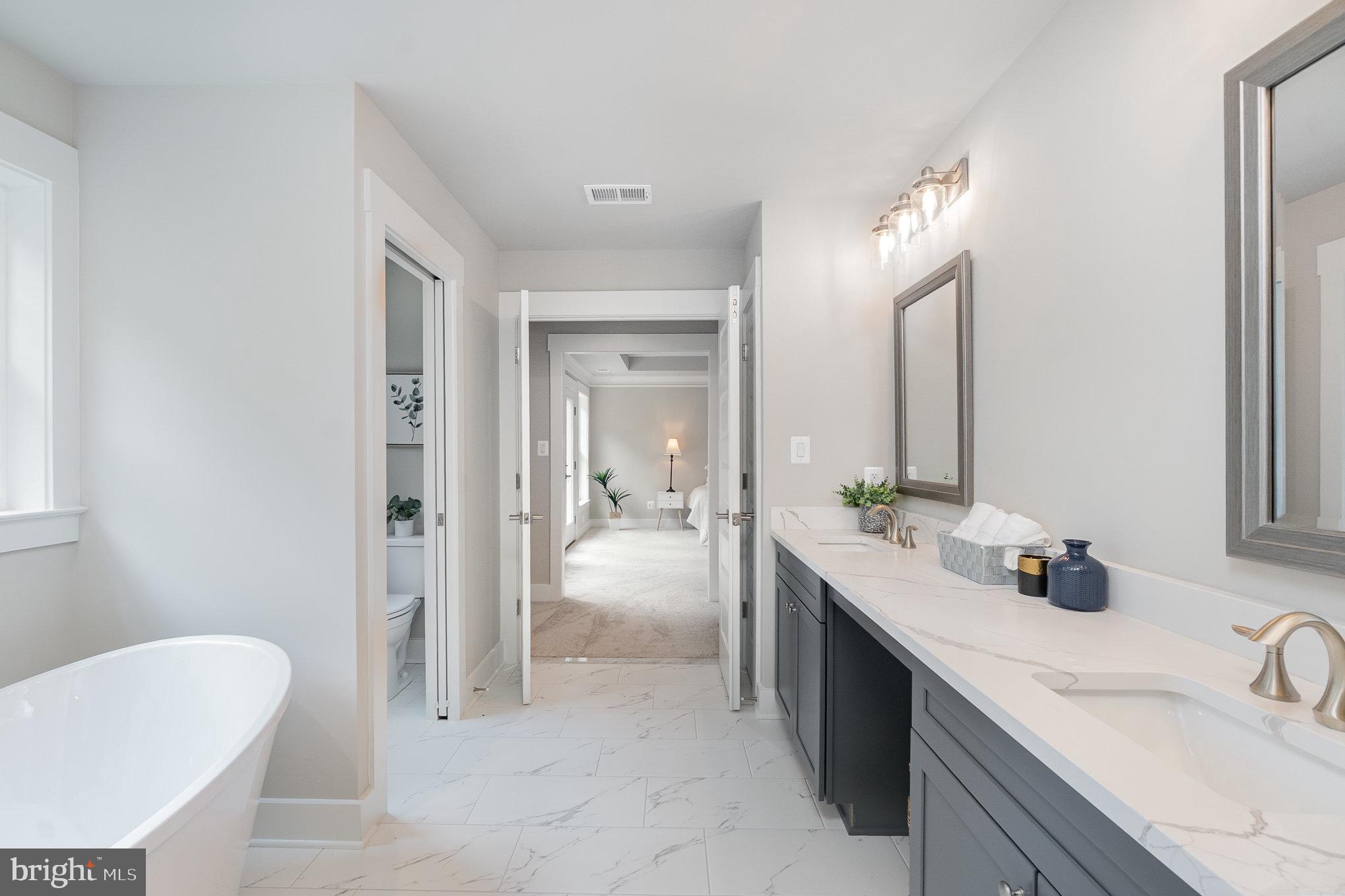 3104 Paper Mill Road Phoenix, MD 21131 - Photo 34 of 77 a spacious bathroom with a double vanity sink mirror and double