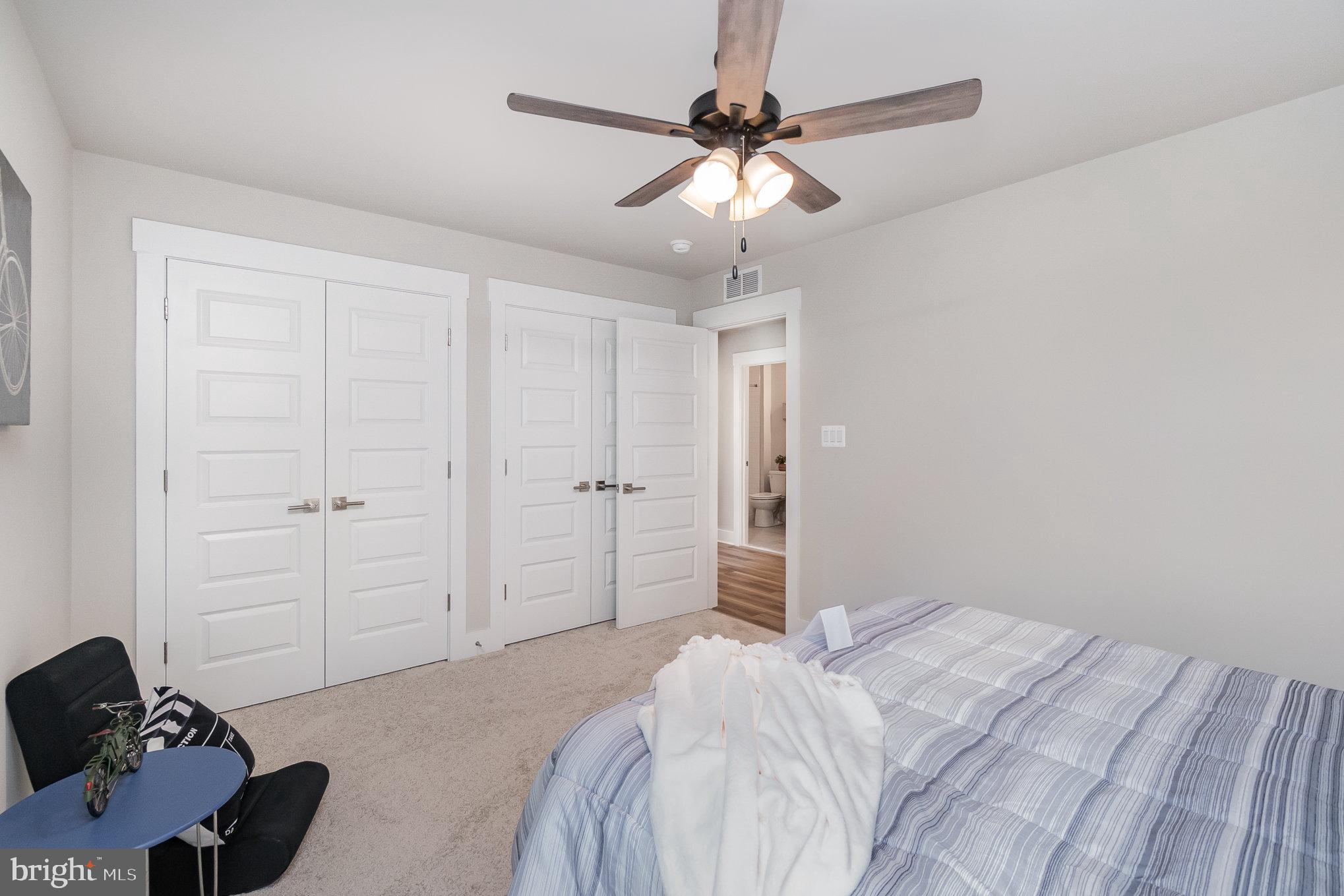 3104 Paper Mill Road Phoenix, MD 21131 - Photo 43 of 77 a bedroom with a bed and a chandelier