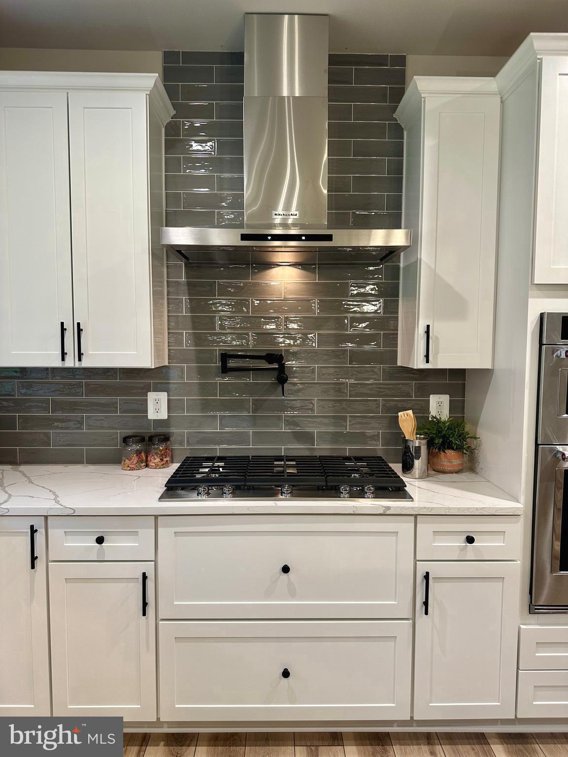 3104 Paper Mill Road Phoenix, MD 21131 - Photo 9 of 77 a kitchen with white cabinets and appliances