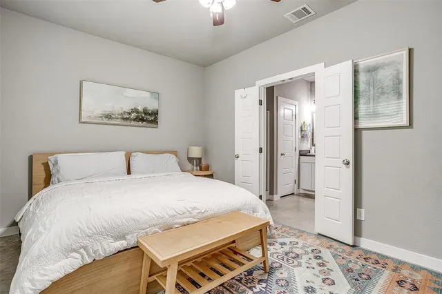 a spacious bedroom with a bed and a window