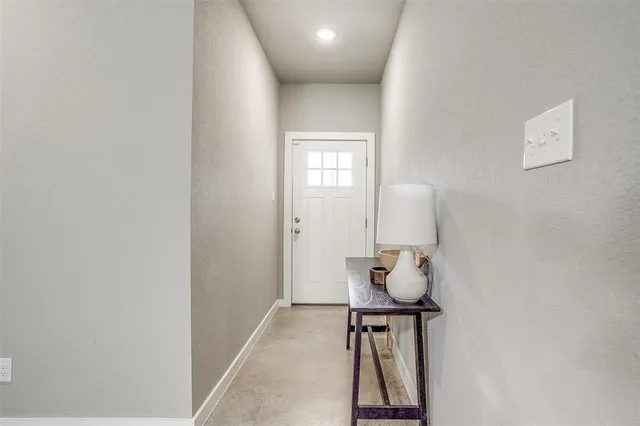 a view of hallway with table and a couch