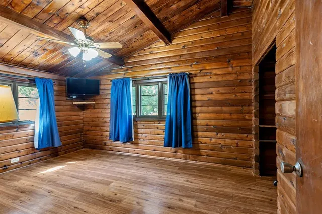 a view of a room with wooden floor and brick wall