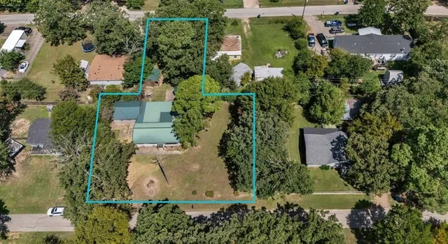 an aerial view of a house with a yard and lake view