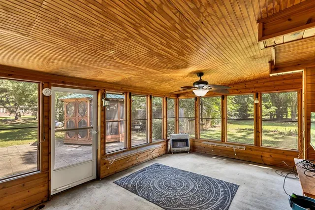 a living room with furniture and large windows