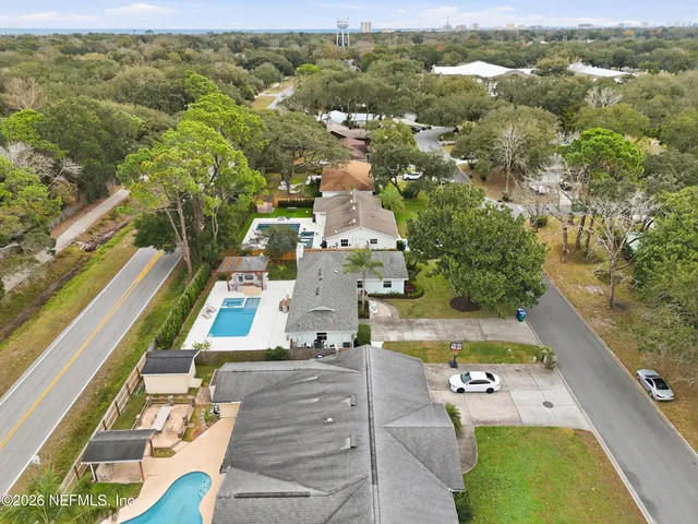 an aerial view of residential houses with yard
