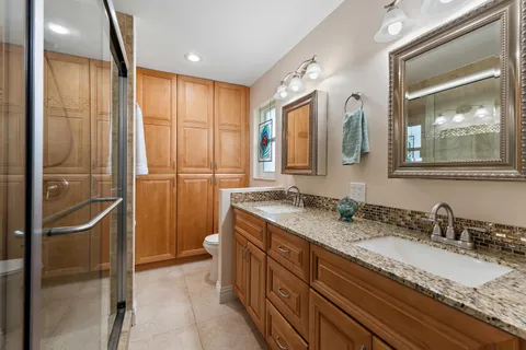 a bathroom with a granite countertop shower mirror and a sink