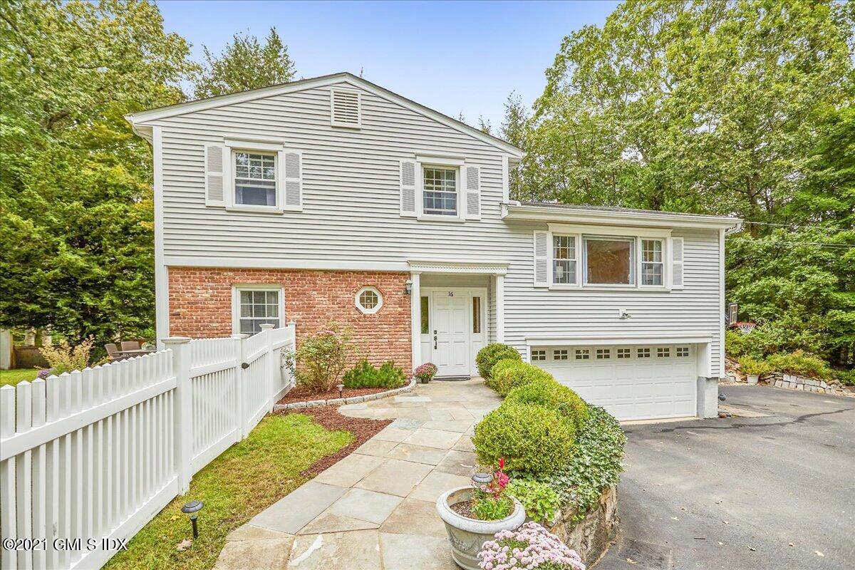 16 Cat Rock Road Cos Cob, CT 06807 - Photo 1 of 26 a front view of a house with a yard and garage