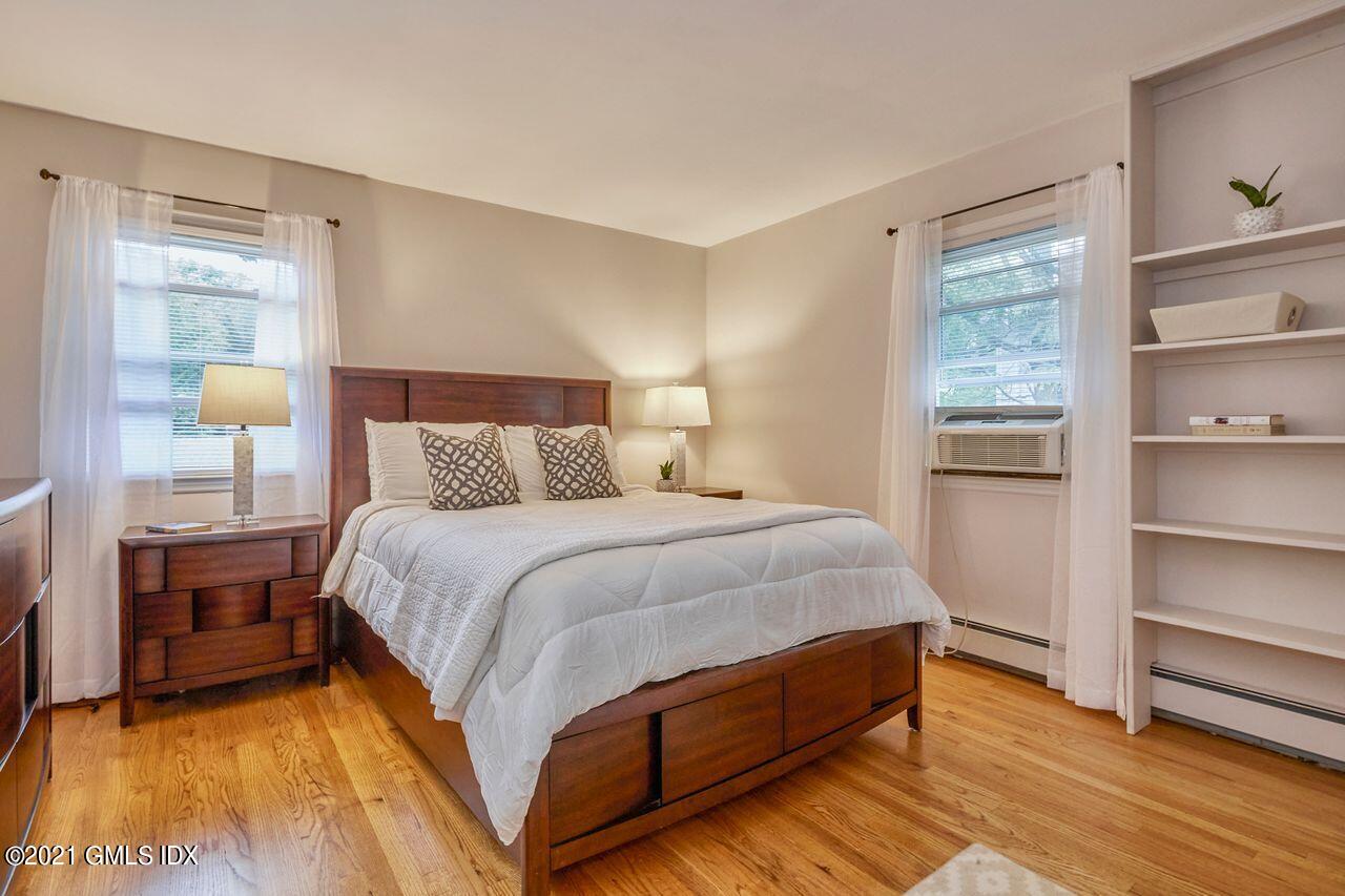 16 Cat Rock Road Cos Cob, CT 06807 - Photo 19 of 26 a bedroom with a bed and wooden floor