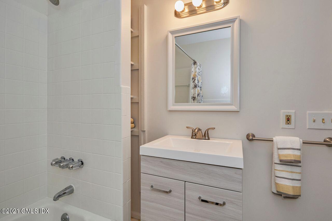 16 Cat Rock Road Cos Cob, CT 06807 - Photo 20 of 26 a bathroom with a sink a vanity and a mirror
