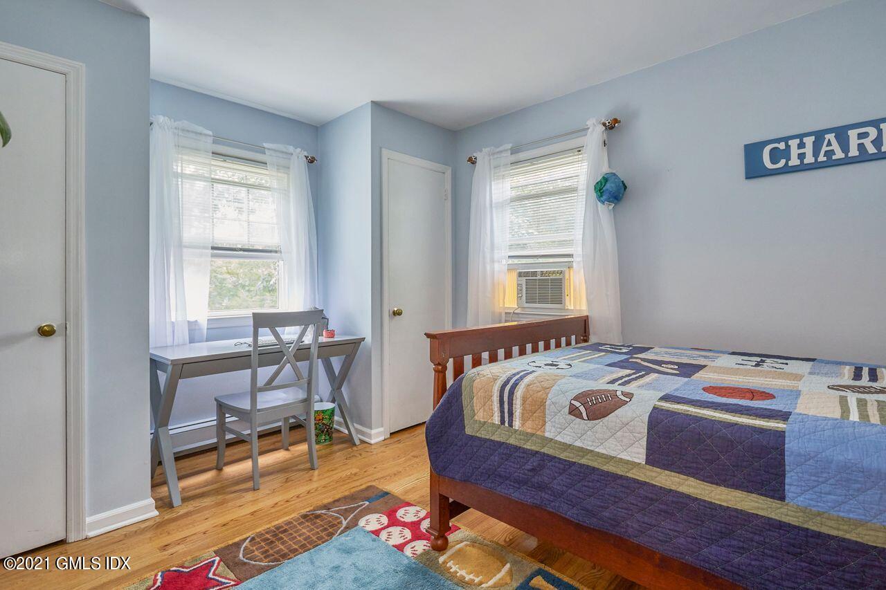 16 Cat Rock Road Cos Cob, CT 06807 - Photo 21 of 26 a bedroom that has a bed and a table in it