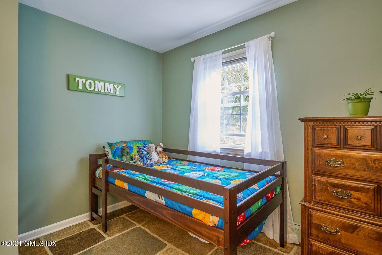 16 Cat Rock Road Cos Cob, CT 06807 - Photo 22 of 26 a room with a bed and a window