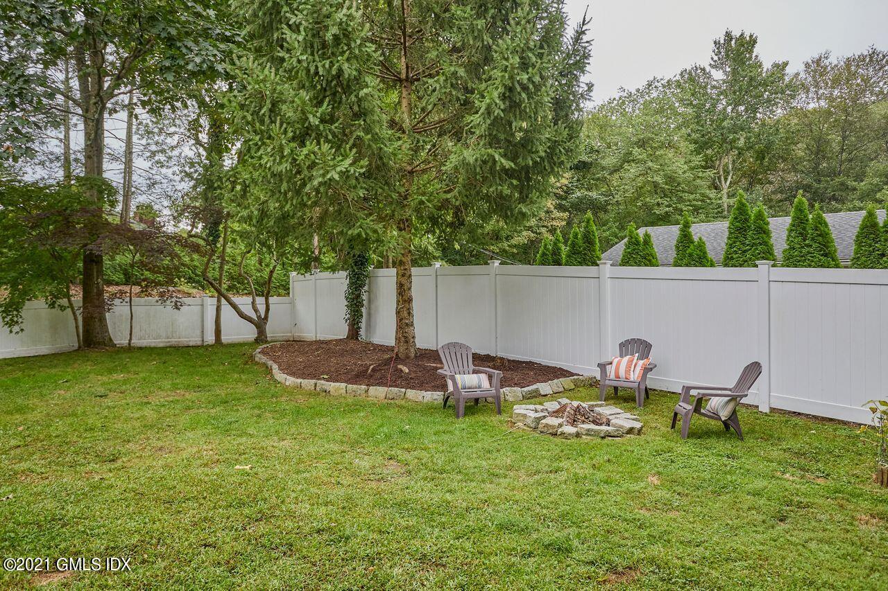16 Cat Rock Road Cos Cob, CT 06807 - Photo 26 of 26 a backyard of a house with table and chairs