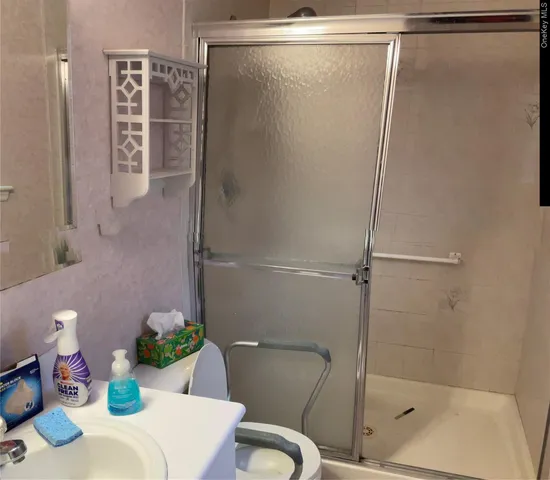 a bathroom with a shower and a sink