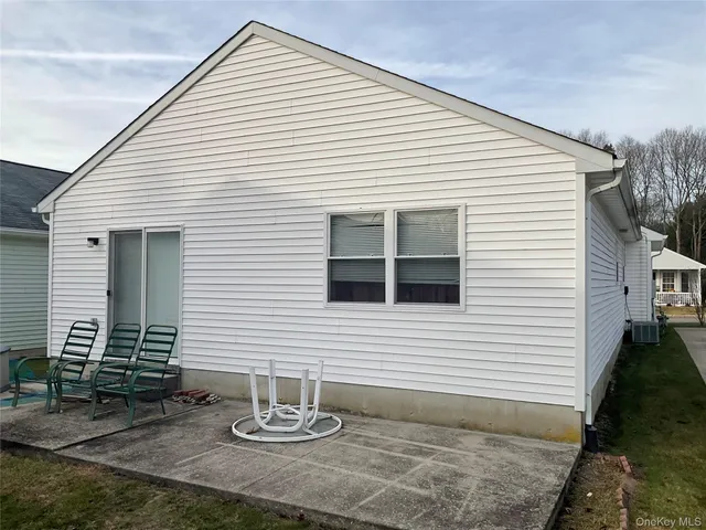 a bathroom with a table and a chair