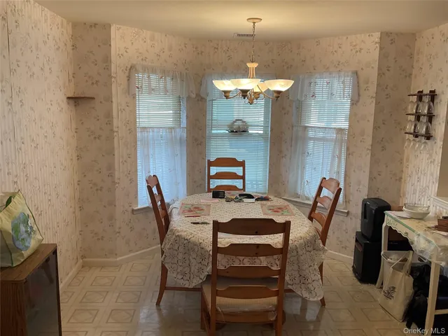a view of a dining room with furniture and chandelier