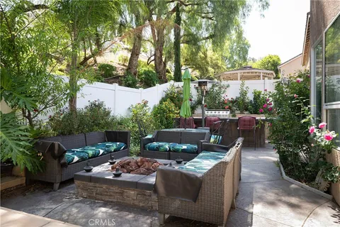 a view of a patio with couches table and chairs and potted plants