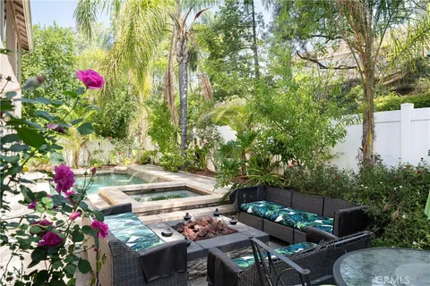 a view of yard with seating area and trees around