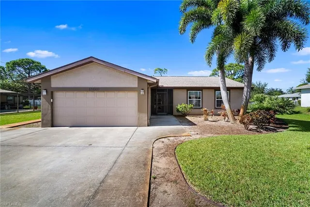 a view of a house with swimming pool and a yard