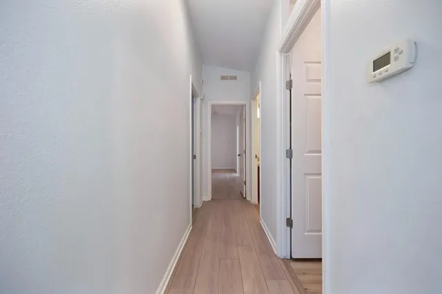 a view of a room with wooden floor