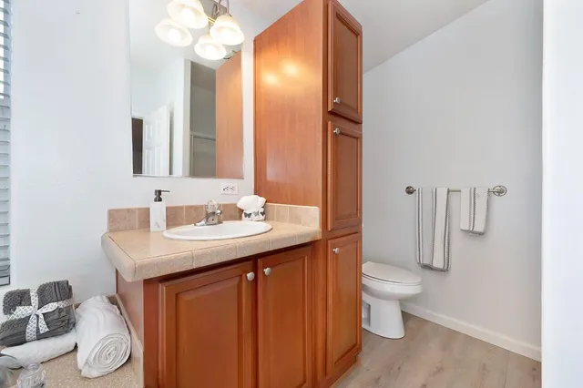 a bathroom with a sink a toilet and a mirror