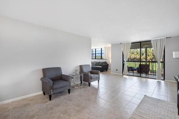 a view of a livingroom with furniture and floor to ceiling window