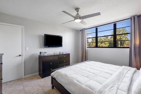 a bedroom with a bed and a flat screen tv