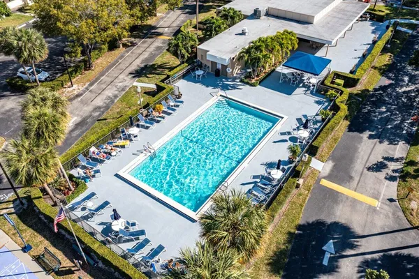 an aerial view of a house a garden and swimming pool