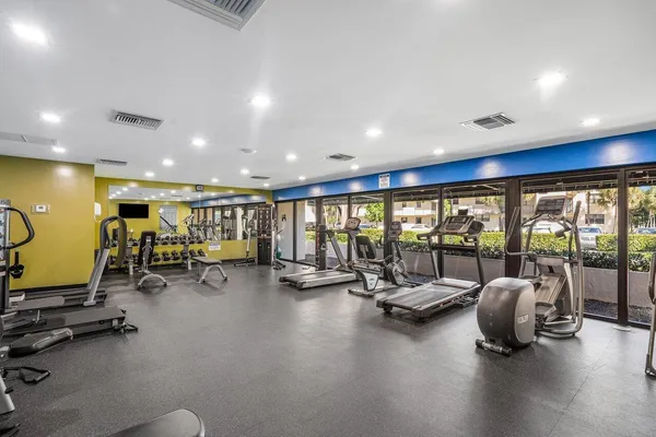 a view of a room with gym equipment and a large window