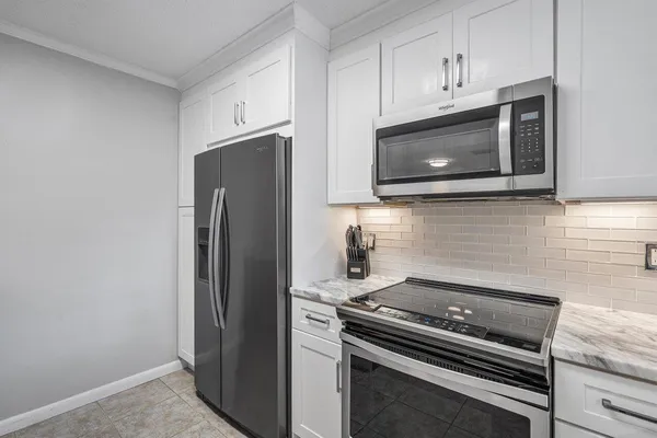 a kitchen with appliances and cabinets