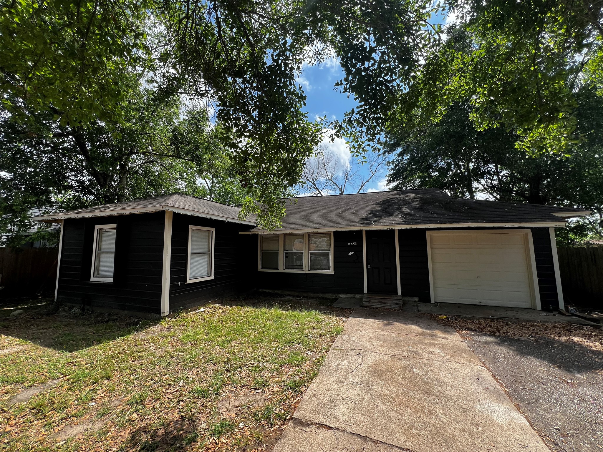 5926 Southtown Street Houston, TX 77033 - Photo 1 of 7 a front view of house with yard and trees around