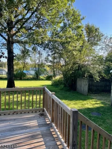 a view of a garden with wooden deck
