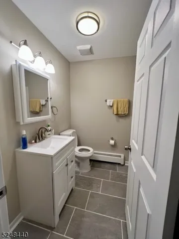 a bathroom with a sink a toilet and mirror