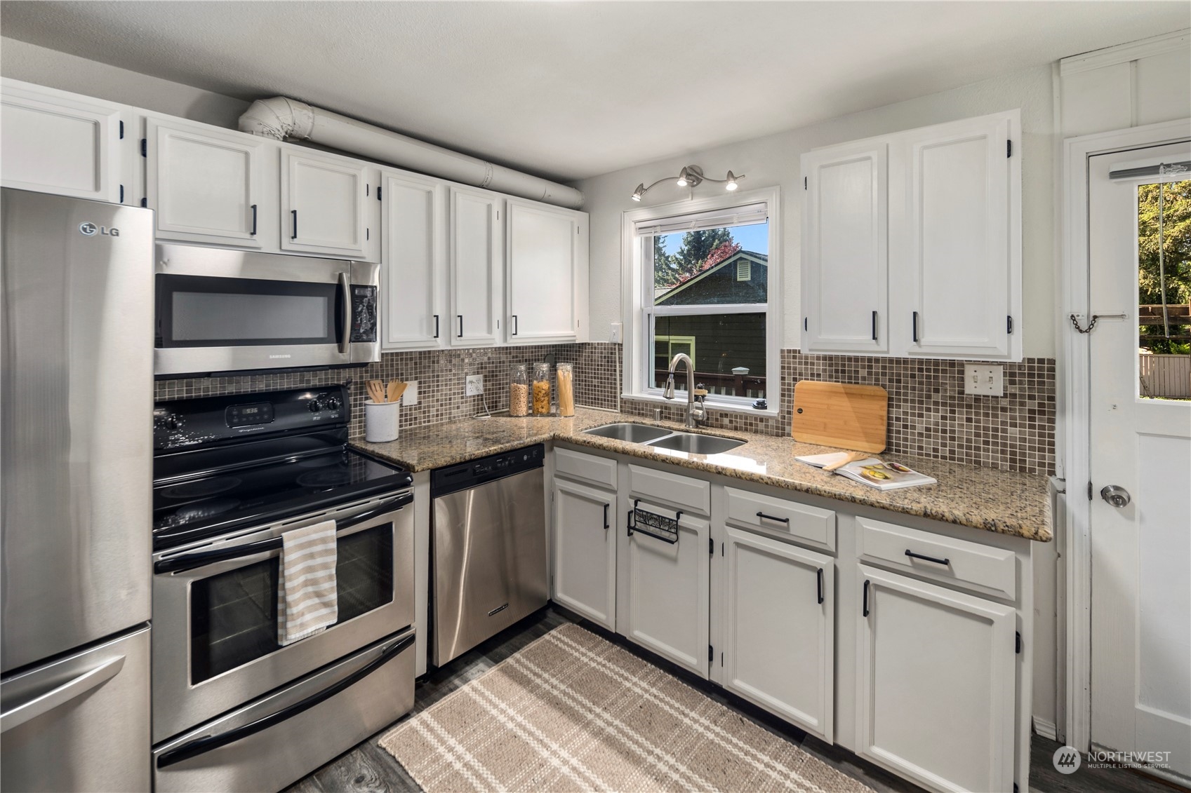 19404 4th Drive Southeast Bothell, WA 98012 - Photo 11 of 33 a kitchen with cabinets stainless steel appliances and a sink