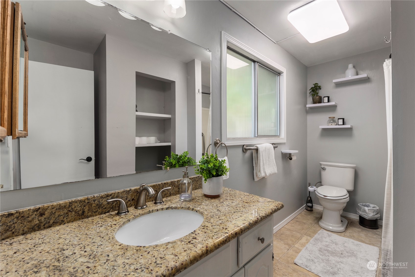19404 4th Drive Southeast Bothell, WA 98012 - Photo 19 of 33 a bathroom with a granite countertop sink and a mirror