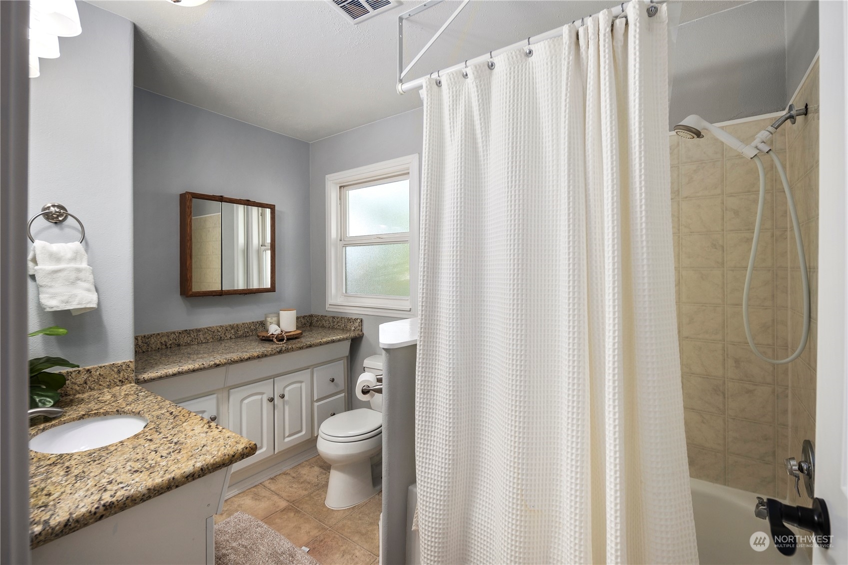 19404 4th Drive Southeast Bothell, WA 98012 - Photo 22 of 33 a bathroom with a granite countertop sink and a mirror