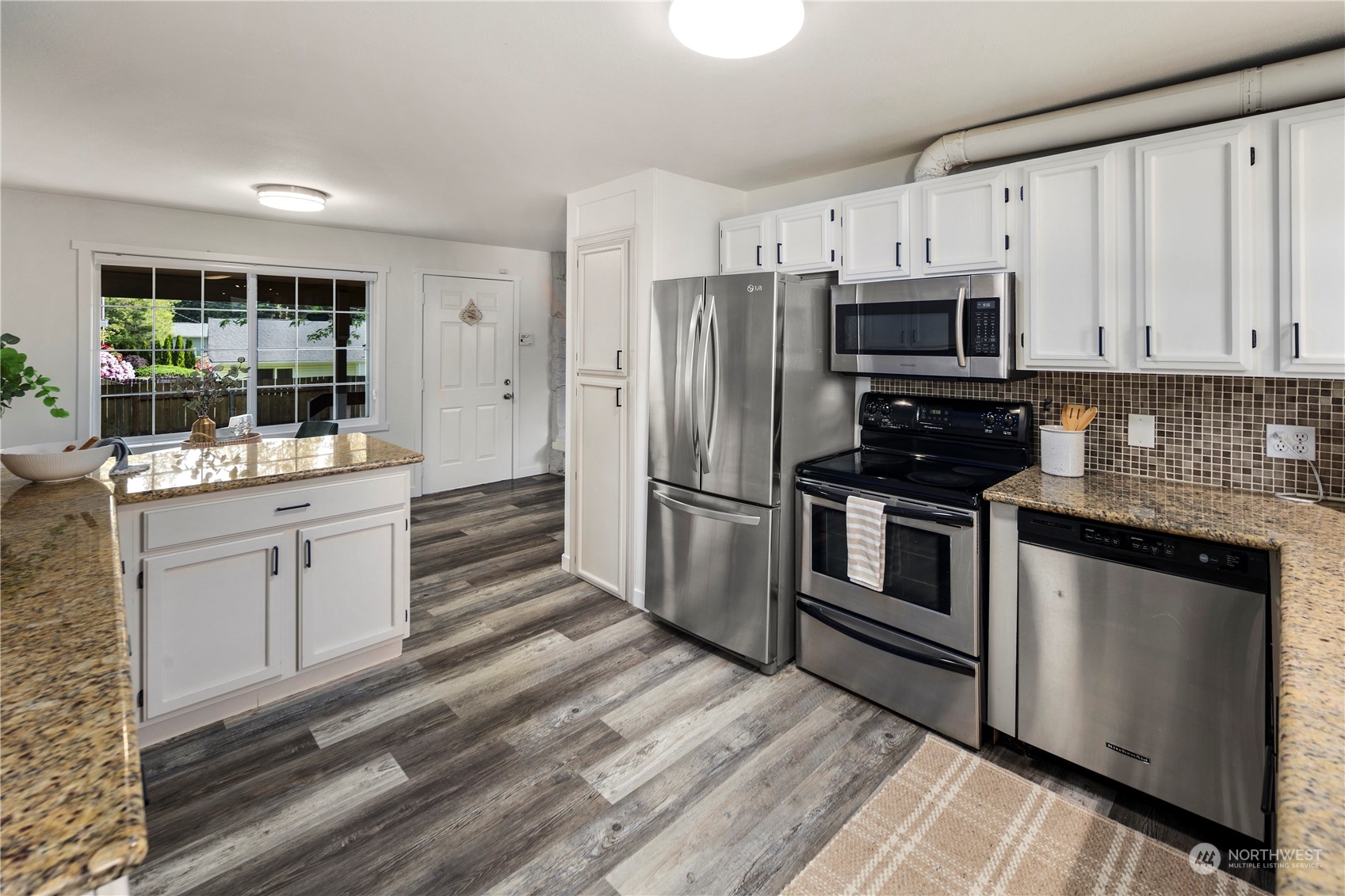 19404 4th Drive Southeast Bothell, WA 98012 - Photo 10 of 33 a kitchen with white cabinets stainless steel appliances and sink