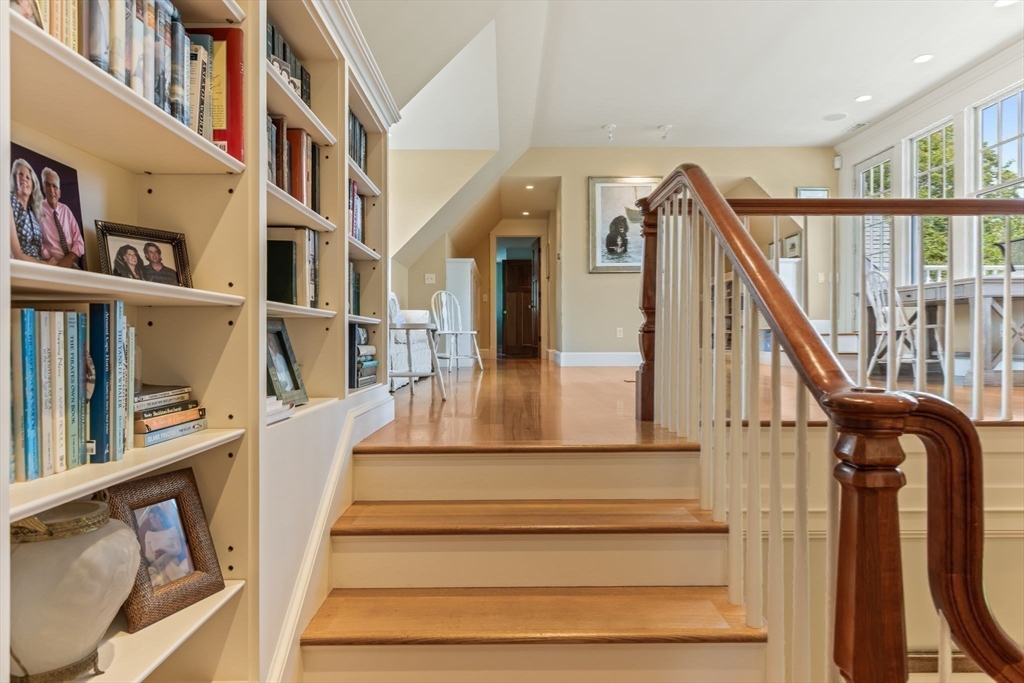 785 Old Harbor Road Chatham, MA 02650 - Photo 21 of 40 a view of staircase with lots of frames on wall and a window