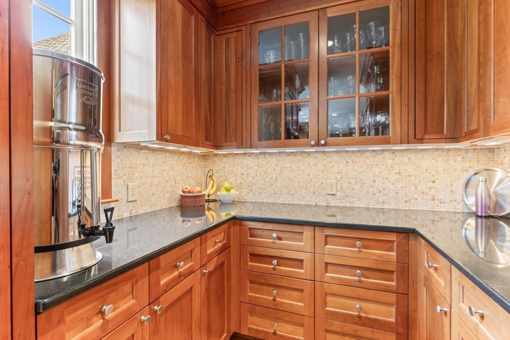 785 Old Harbor Road Chatham, MA 02650 - Photo 8 of 40 a kitchen with stainless steel appliances granite countertop a sink and cabinets