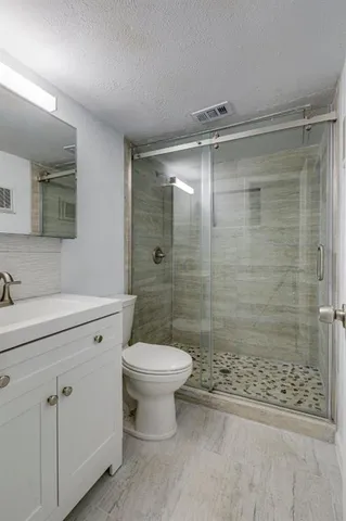 a bathroom with a sink mirror toilet and shower