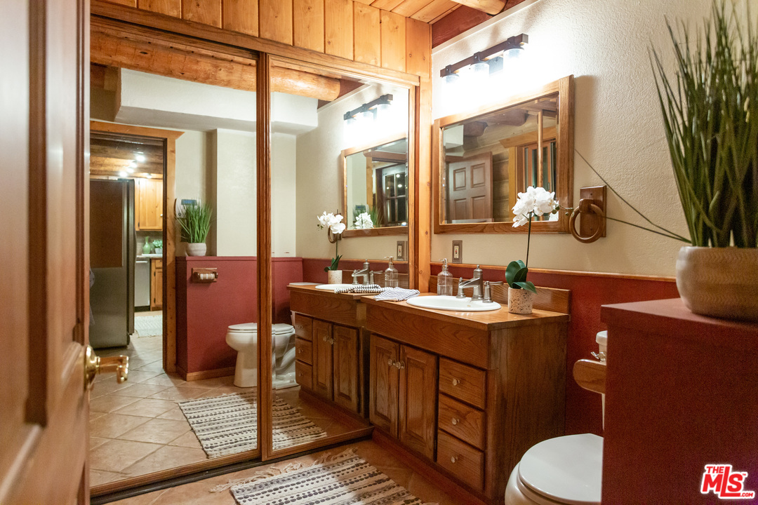 7429 Studio Road West Hills, CA 91304 - Photo 31 of 44 a bathroom with a sink mirror and toilet