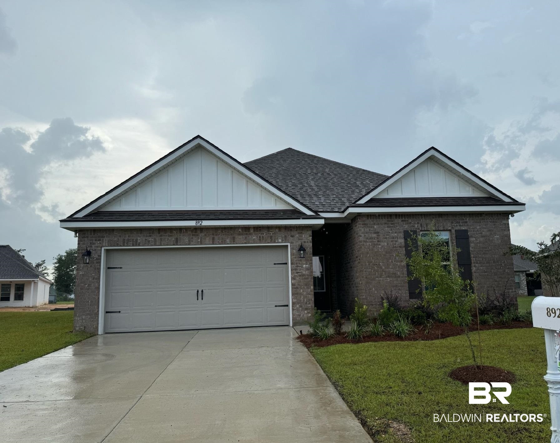 View of front of home with a garage and a front yard