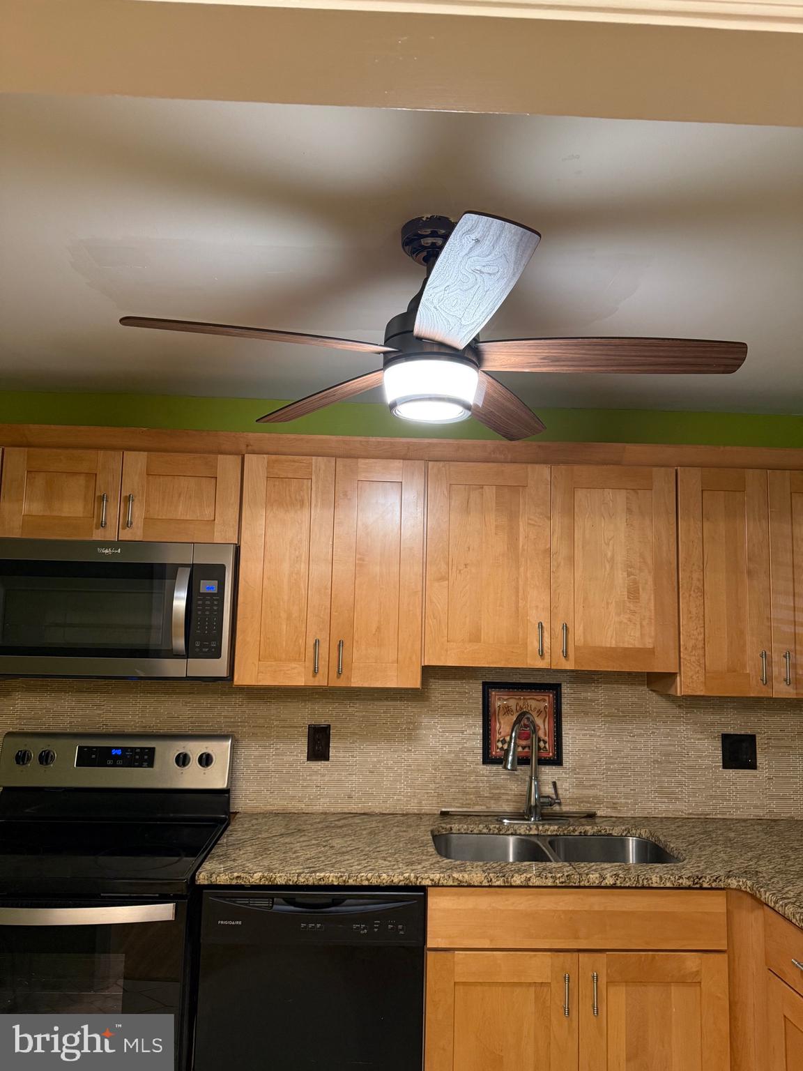 250 East Avon Road Brookhaven, PA 19015 - Photo 39 of 61 a kitchen with stainless steel appliances granite countertop a stove a sink and a microwave