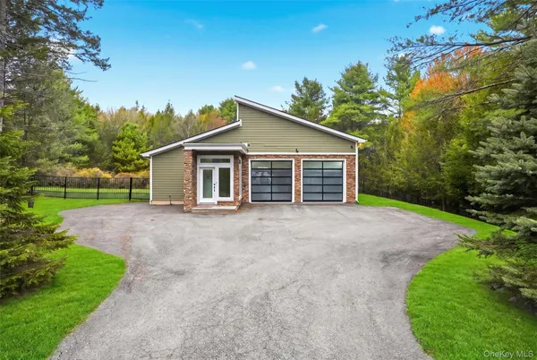 a view of a house with a yard and garage