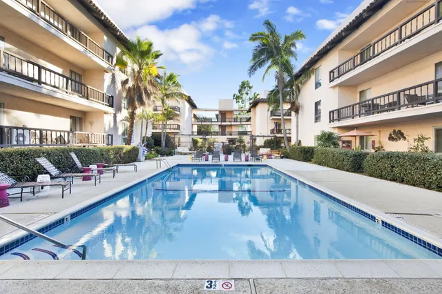 a view of a swimming pool with outdoor seating