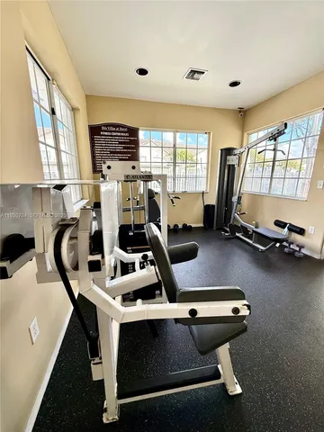 a room with gym equipment and a large window