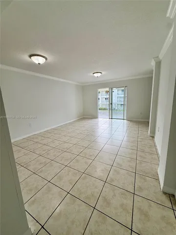 a view of a livingroom with an empty space and a window